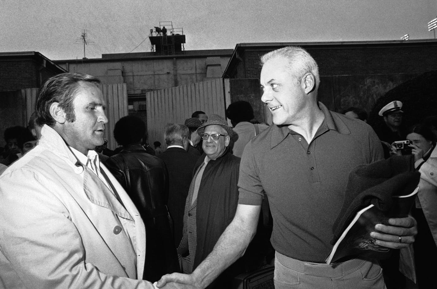 Miami coach Don Shula, the winner, is rather grim while the loser, Minnesota coach Bud Grant, has a smile as they meet in the Rice Stadium tunnel following the Super Bowl game on Sunday, Jan. 13, 1974 in Houston, Texas.