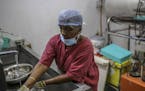 A worker washes medical surgical equipment with water next to opration theater at Sudar Hospital in Chennai, India, on Jul. 4, 2019. MUST CREDIT: Bloo