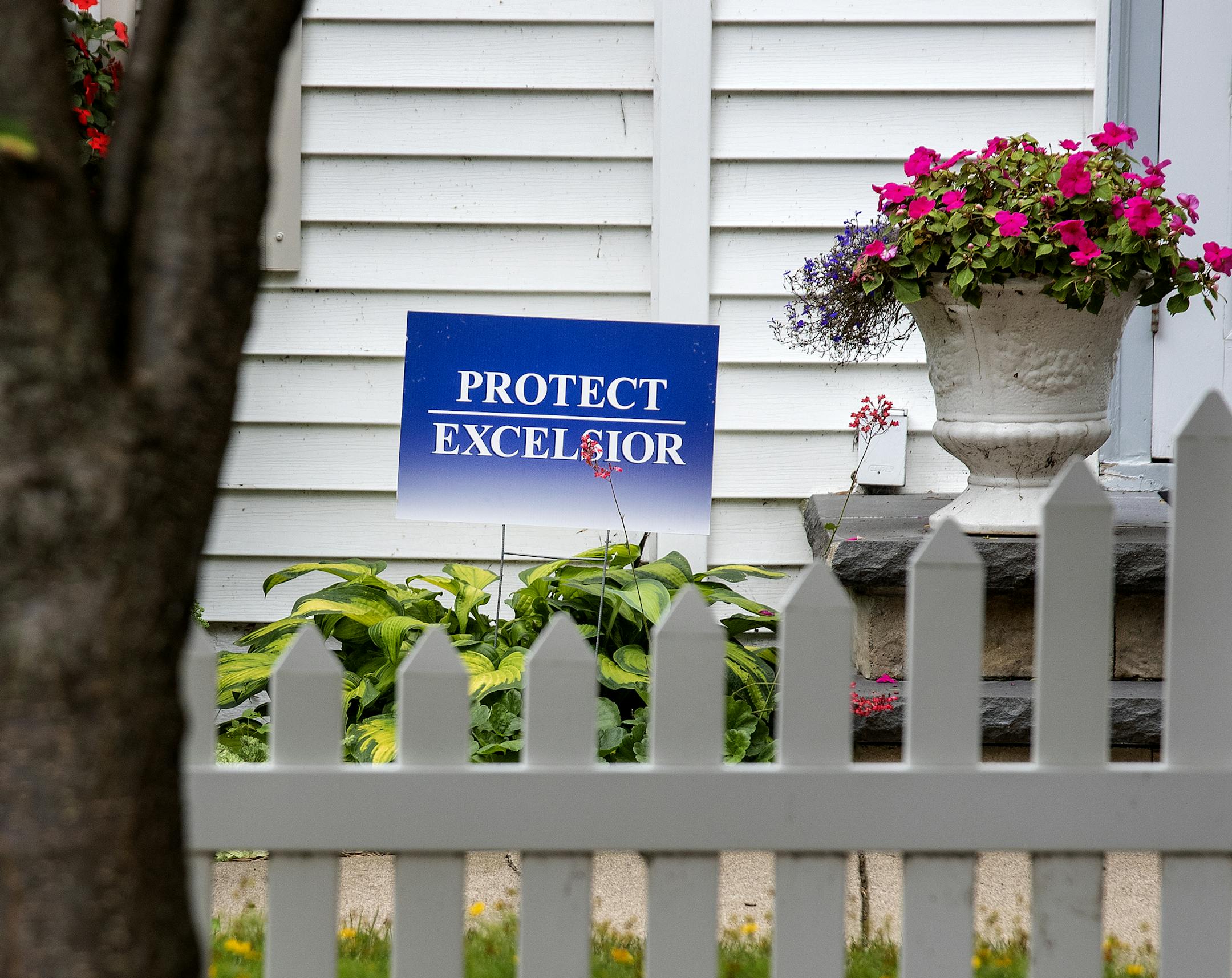 A "Protect Excelsior" sign in front of a home in Excelsior, MN. ] CARLOS GONZALEZ &#xef; cgonzalez@startribune.com &#xf1; August 1, 2018, Excelsior, MN, The "Protect Excelsior" signs are still up after the city voted in May for more restrictions regarding new residential developments from going up in this charming Lake Minnetonka town.