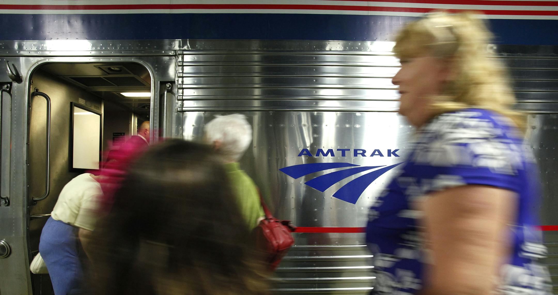 Passengers traveling west on Amtrak's Empire Builder board the train en route to St. Paul, Minn., Thursday, July 14, 2011, in Chicago. Prolonged flooding along the Missouri River disrupted Amtrak service throughout the Midwest and west, including the Empire Builder, its most popular cross-country route. Amtrak officials say theyíre the longest-lasting line closures at least a decade, and have hurt ridership during an otherwise strong year. (AP Photo/Charles Rex Arbogast) ORG XMIT: ILCA201