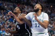 Nets center Day'Ron Sharpe and Timberwolves center Karl-Anthony Towns fought for position under the basket in the first quarter Saturday at Target Cen