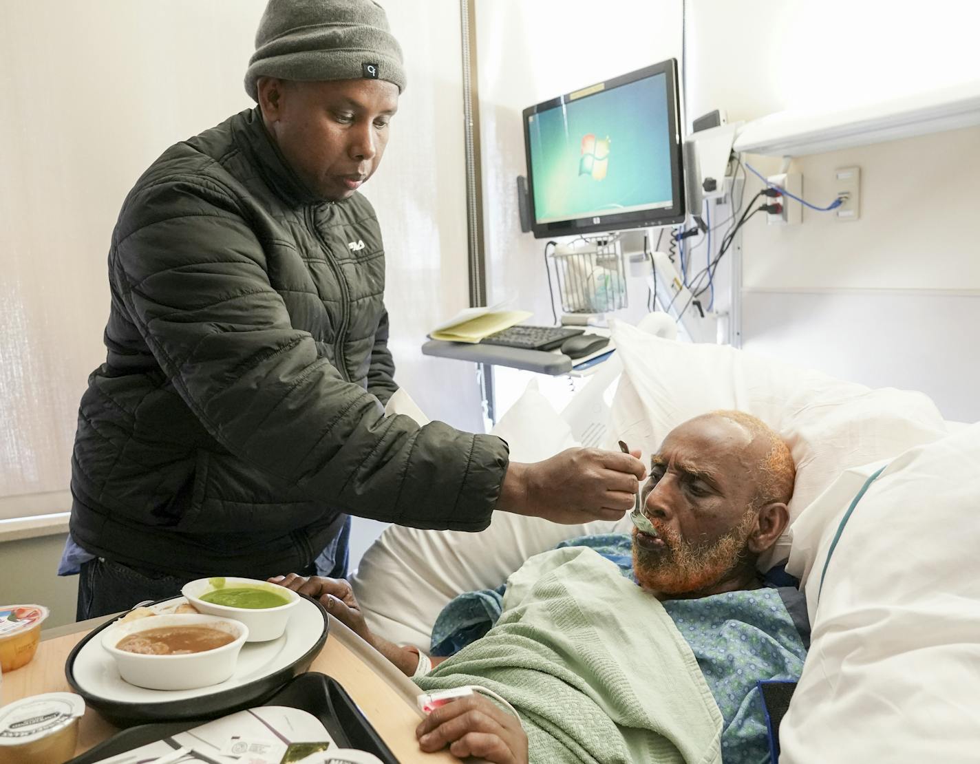 Nur Abdullahi watched over his father, Salad Samatar, who is recovering at HCMC from injuries he sustained in last week's high-rise fire in Minneapolis.