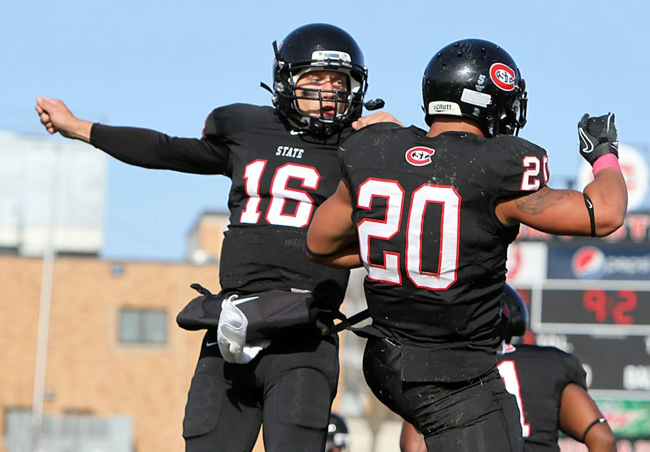 St Cloud State University's No 16 Phillip Klaphake and No 20 Michael Walker celebrate Walker's touchdown in the second quarter against University of Minnesota Duluth during the Northern Sun Intercollegiate Conference game Saturday, October 29, 2011, at Husky Stadium.The Huskies win 35-7.