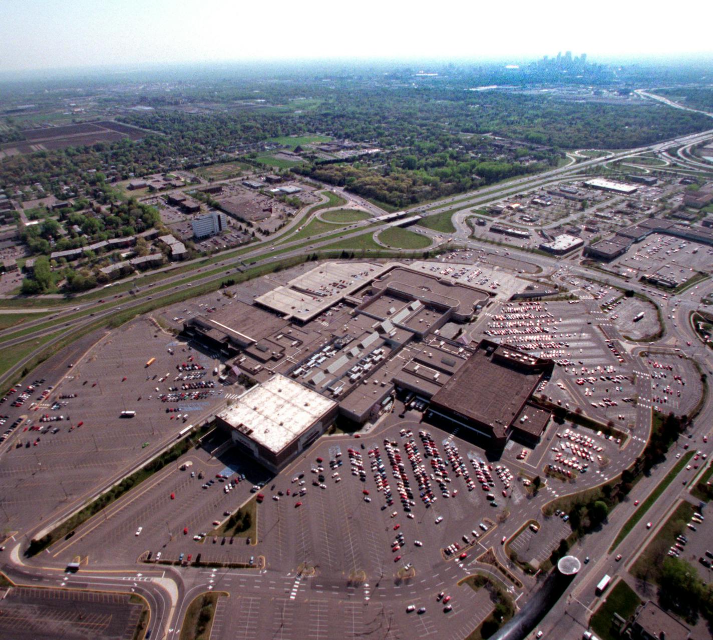 Joe Kimball is doing a 50th anniversary of Roseville story. We shoot aerials to see what it looks like today. -- This is Rosedale, the shopping center, what many people probobly think IS Roseville. We are looking towards the SW from about1500 feet overhead. In the distance (top right) downtown Minneapolis shimmers on the horizon. At left is Snelling Avenue, and running diagonally from middle left to upper right (towards downtown Minneapolis) is Highway 36.