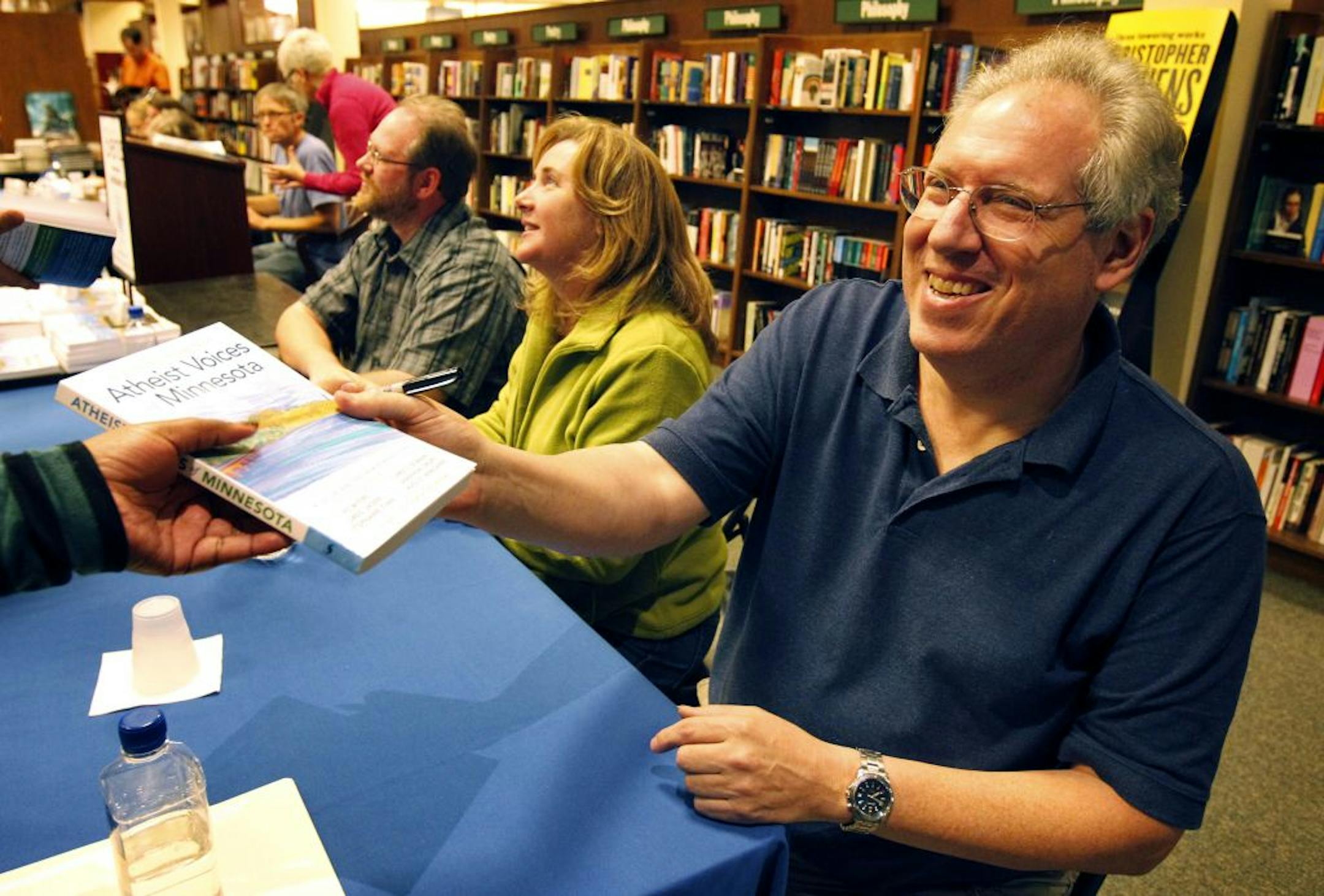 August Berkshire, president of Minnesota Atheists, signed copies with other essay writers from the book "Atheist Voices of Minnesota" in Roseville last week.