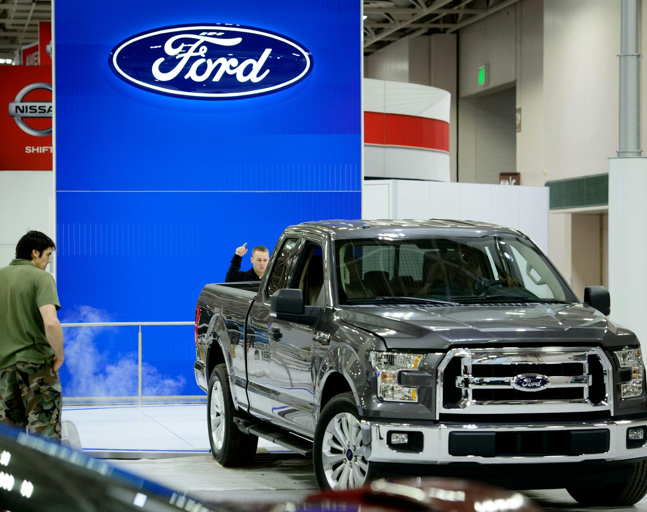 EWI Worldwide exhibition manager Chris Caylor directed the driver of a charcoal F-150 up onto a circular stage. The frame is all aluminum. ] GLEN STUBBE * gstubbe@startribune.com Friday March 7, 2014 The Twin Cities Auto Show runs through March 16.