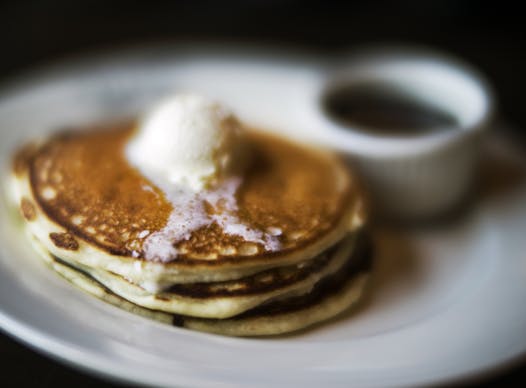 The short stack pancakes comes plain or in variety of flavors. They are served with whipped butter and maple syrup.