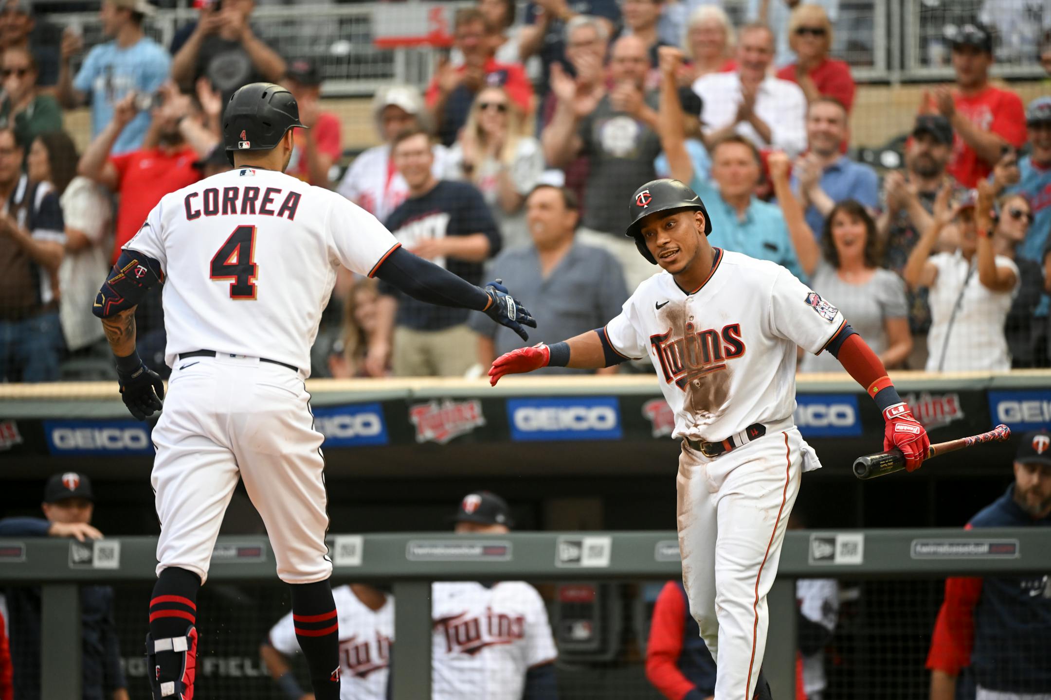 Minnesota Twins shortstop Carlos Correa (4) and second baseman Jorge Polanco (11) celebrate a solo home run hit by Correa against the New York Yankees in the bottom of the first inning.