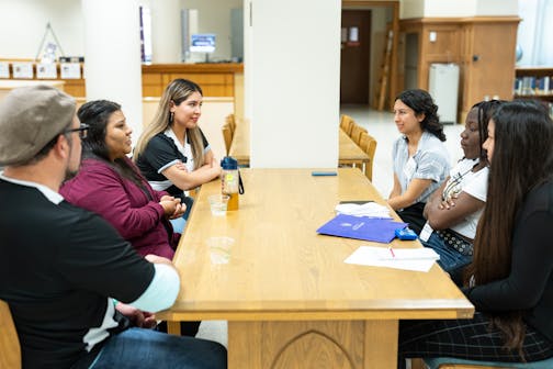 Students and journalist mentors interview sources on ThreeSixty Journalism News Reporter Academy sourcing day in the O'Shaughnessy-Frey Library on June 21, 2023, in St. Paul.