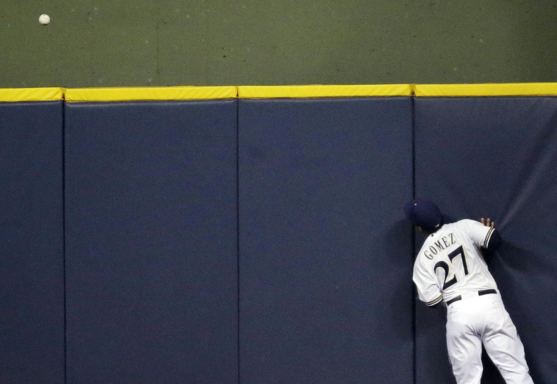 Milwaukee Brewers center fielder Carlos Gomez watches a home run hit by Minnesota Twins' Aaron Hicks during the fourth inning of a baseball game Tuesday, May 28, 2013, in Milwaukee. (AP Photo/Morry Gash)