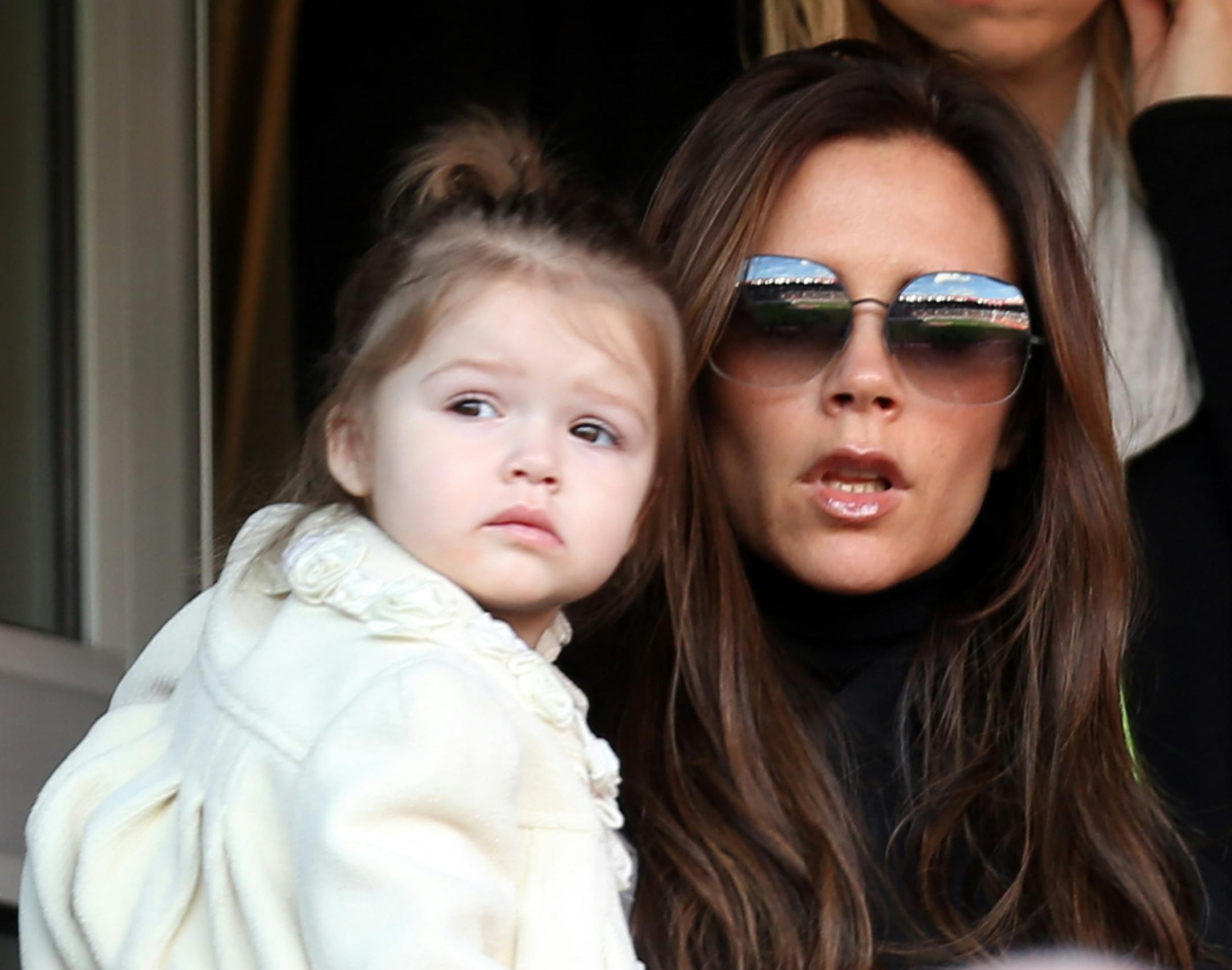 Paris Saint Germain's midfielder David Beckham's wife, Victoria Beckham holds her daughter Harper, as she arrives for League One soccer match between Paris Saint Germain and Nancy, at the Parc des Princes stadium, in Paris, Saturday, March 9, 2013. (AP Photo/Thibault Camus) ORG XMIT: XTC103