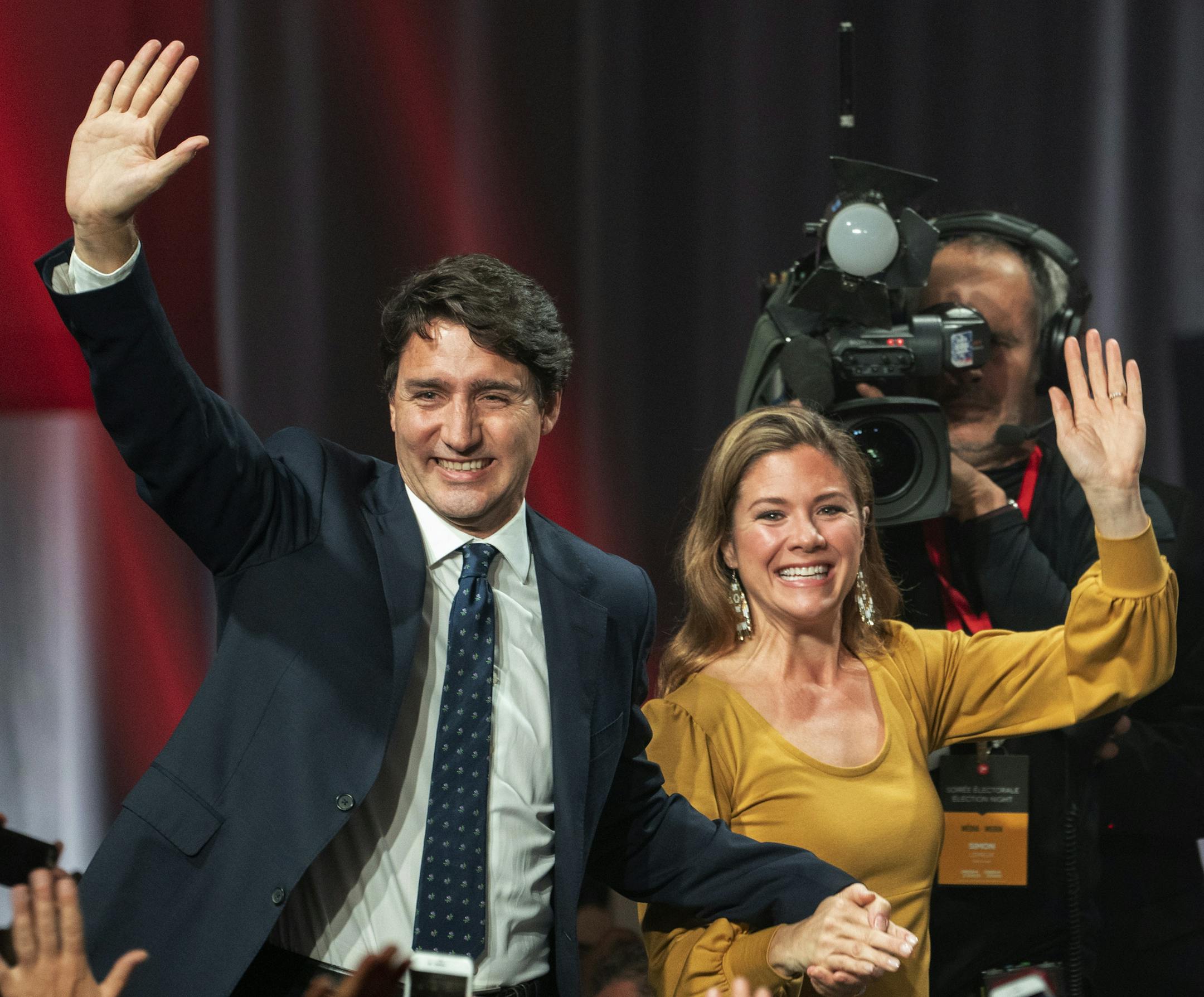 Liberal leader Justin Trudeau and wife Sophie Gregoire Trudeau wave as they go on stage at Liberal election headquarters in Montreal, Monday, Oct. 21, 2019. (Paul Chiasson/The Canadian Press via AP)