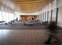 Temple Israel congregants s checked out the new lobby before Friday night services. At left, a wall of windows looks out to a courtyard connecting the