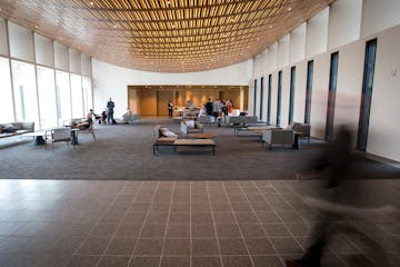 Temple Israel congregants s checked out the new lobby before Friday night services. At left, a wall of windows looks out to a courtyard connecting the