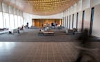 Temple Israel congregants s checked out the new lobby before Friday night services. At left, a wall of windows looks out to a courtyard connecting the