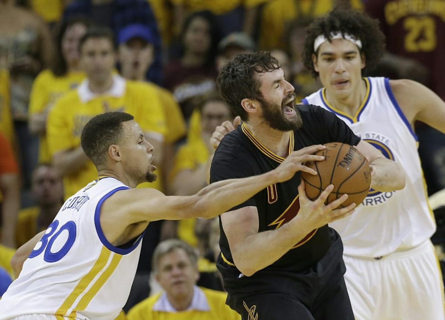 Cleveland Cavaliers forward Kevin Love, center, is defended by Golden State Warriors guard Stephen Curry (30) and forward Anderson Varejao during the first half of Game 7 of basketball's NBA Finals in Oakland, Calif., Sunday, June 19, 2016.