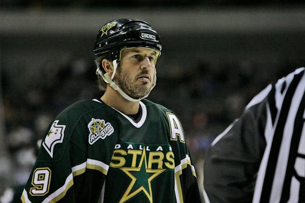 Dallas Stars center Mike Modano talks with a referee in the first period of an NHL hockey game against the Minnesota Wild, Tuesday, Feb. 6, 2007, in D