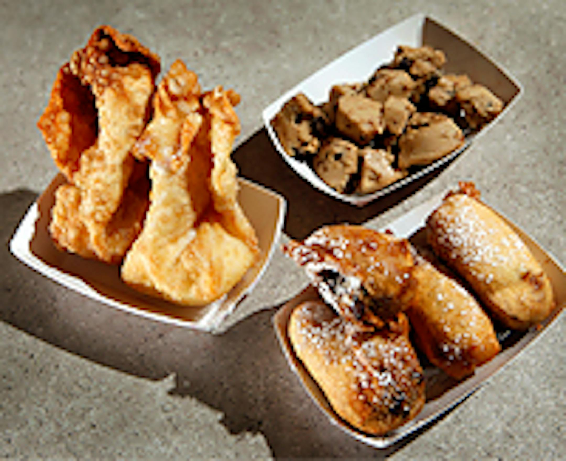 Clockwise from top - frozen cookie dough, deep fried cookie dough with a sweet cake batter and chocolate chip cookie dough, and cream cheese comets - deep-fried wrap with flavored cream cheese