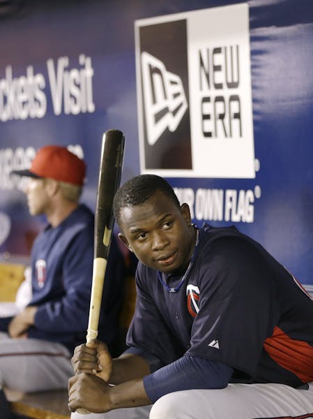 Minnesota Twins top prospect Miguel Sano in the dugout in a spring training baseball game in Tampa, Fla., Thursday, March 21, 2013. (AP Photo/Kathy Wi