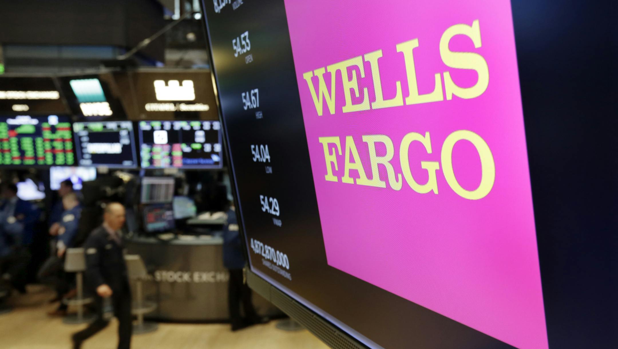 FILE- In this May 17, 2018, file photo, the logo for Wells Fargo appears above a trading post on the floor of the New York Stock Exchange. Wells Fargo reports earnings Friday, July 13, 2018. (AP Photo/Richard Drew, File) ORG XMIT: NYBZ557