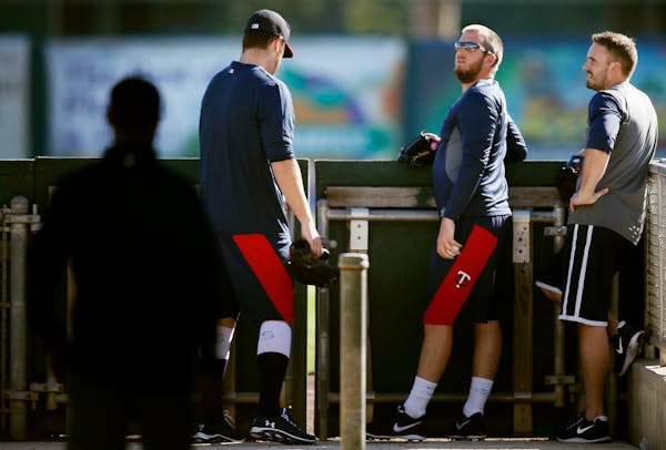 Twins pitchers Phil Hughes, left, and Glen Perkins at Hammond Stadium in Fort Myers, Fla., in 2014.