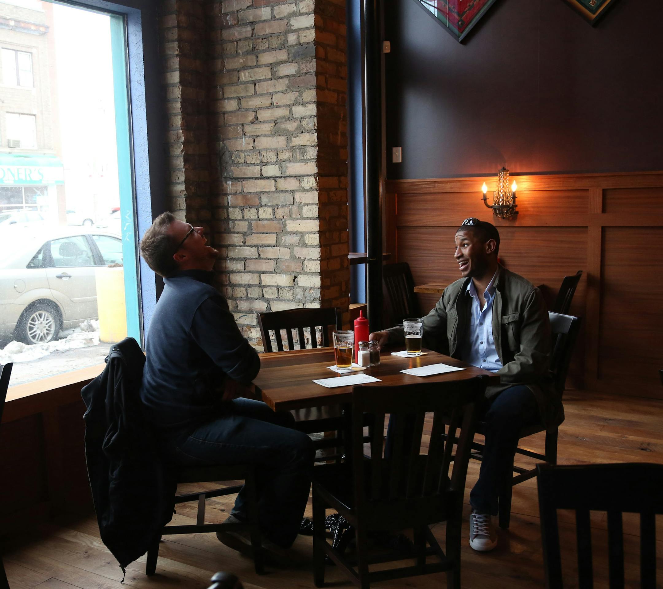 Dan Blackburn, left, and Caleb Moore talked and laughed as they enjoyed the reopened Town Hall Brewery. ] (KYNDELL HARKNESS/STAR TRIBUNE) kyndell.harkness@startribune.com The beginning of Barrel- Aged Beer Week and the reopening of Town Hall Brewery in Minneapolis Min, Saturday, April 5, 2014.