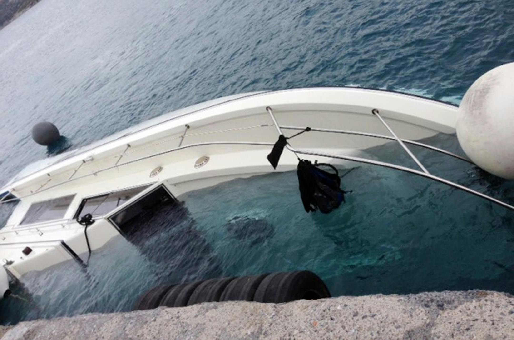 A yacht used to transport immigrants illegally that overturned in a fatal accident is seen at the port of Vathy on the Greek island of Samos, on Monday, May 5, 2014. At least 22 people drowned in the incident in the eastern Aegean Sea, while 36 were rescued and others remain missing. Coast guard officials recovered the bodies of two women, a man and a boy from the sea, and later found a further 18 bodies, including three children, inside the yacht after it was towed to Samos.