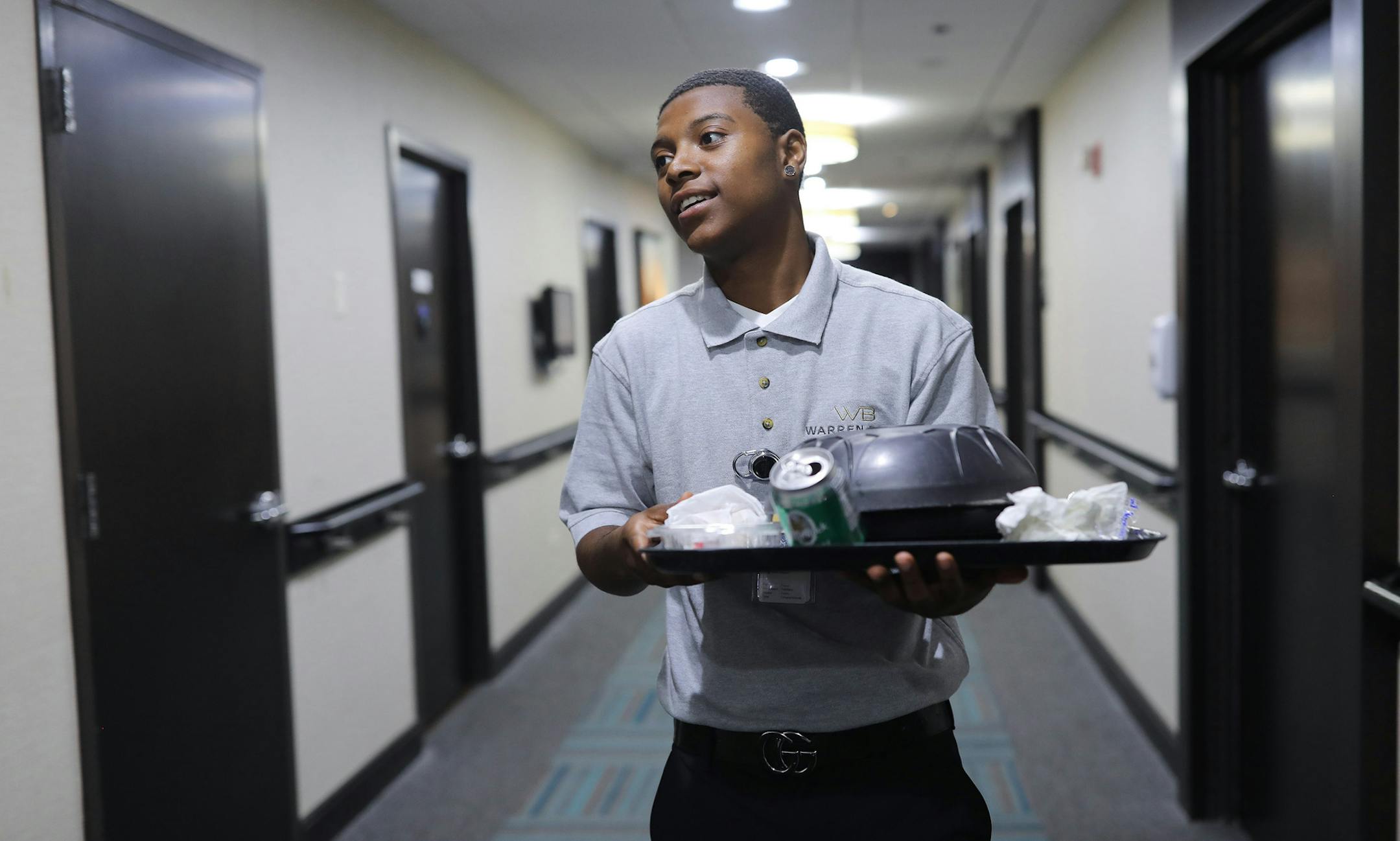 Recent CPS graduate Jeremy Mitchell is a concierge at Warren Barr Gold Coast rehabilitation facility who helps patients with their food and keeps them company. (Abel Uribe/Chicago Tribune/TNS) ORG XMIT: 1413312