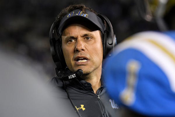 FILE - In this Nov. 24, 2017, file photo, UCLA interim coach Jedd Fisch talks to his players during the first half of an NCAA college football game ag