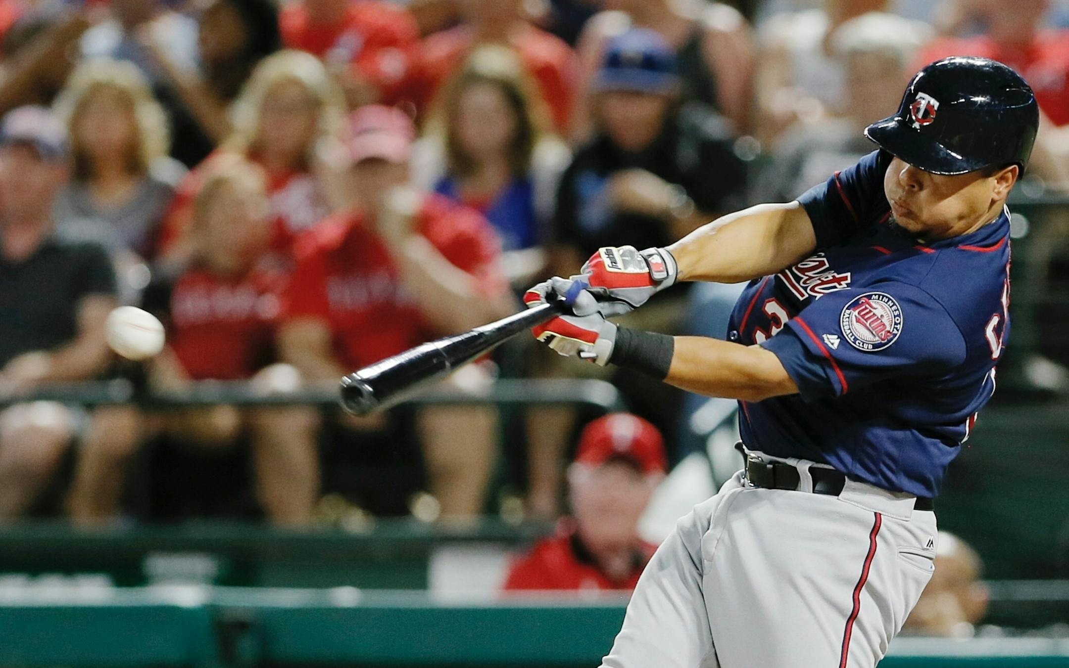 Minnesota Twins' Juan Centeno makes contact for a two-run single during the second inning of a baseball game against the Texas Rangers on Saturday, July 9, 2016, in Arlington, Texas. (AP Photo/Brandon Wade)