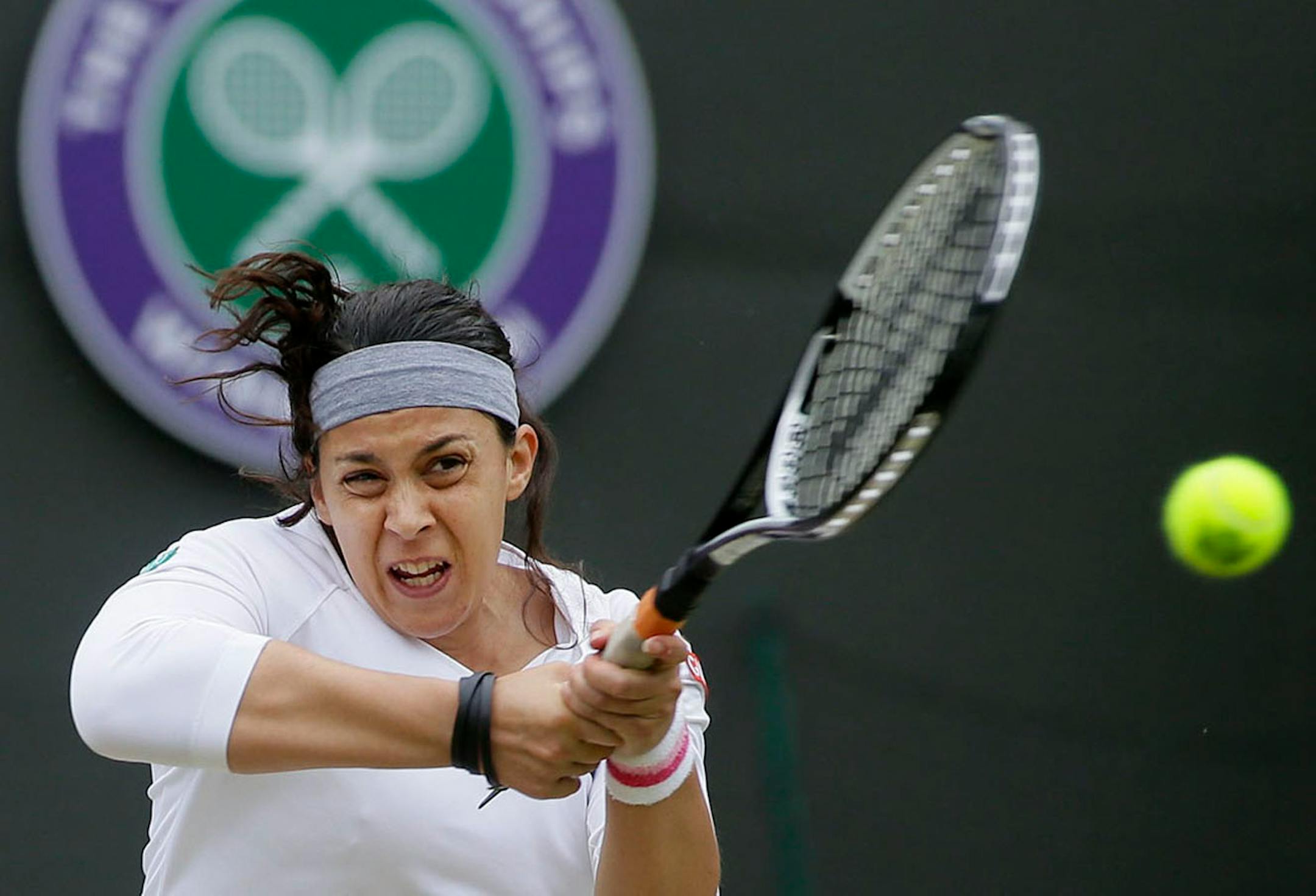 Marion Bartoli of France plays a return to Sloane Stephens of the United States in a Women's singles quarterfinal match.