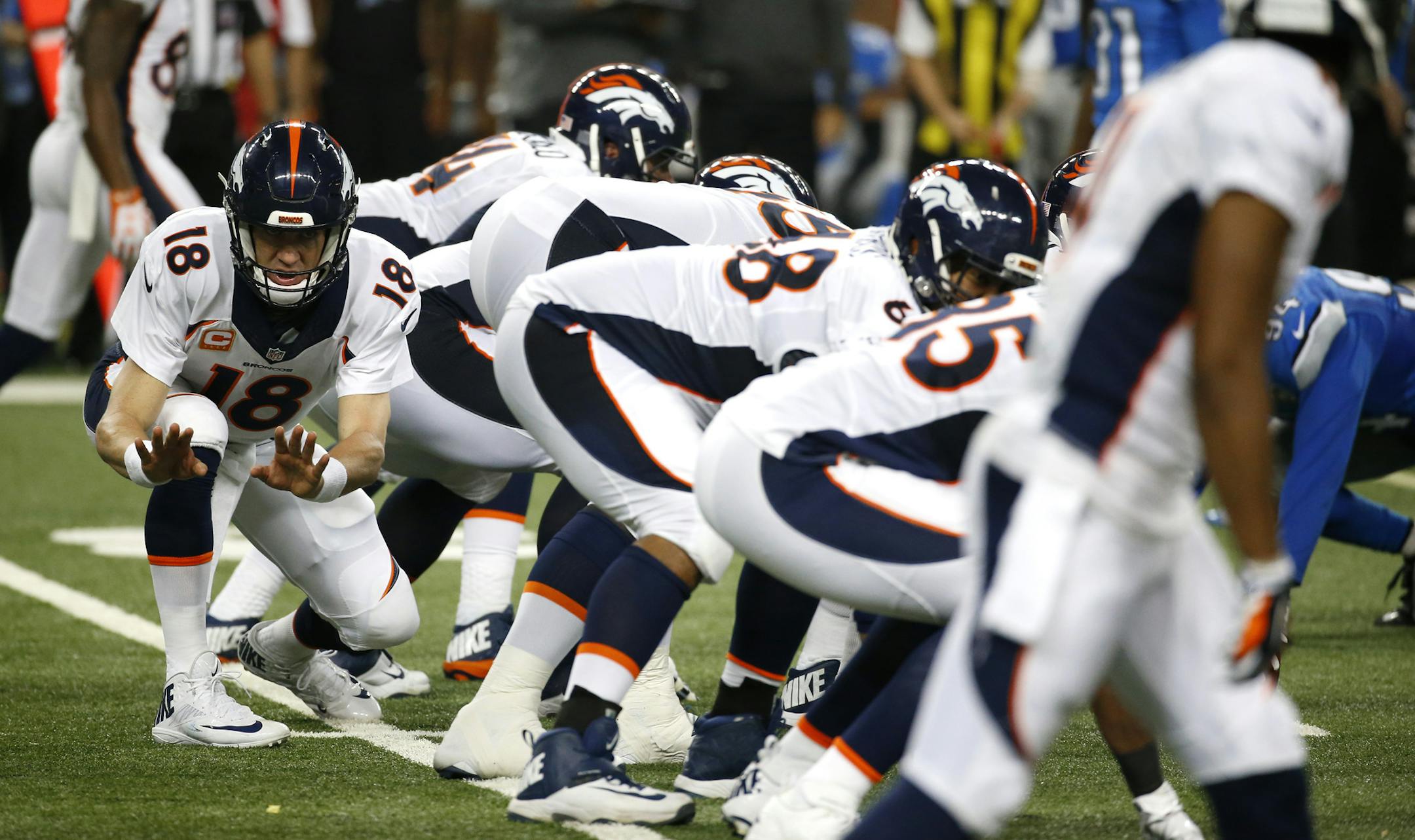 Denver Broncos quarterback Peyton Manning (18) signals a play at the line of scrimmage against the Detroit Lions during the second half of an NFL football game, Sunday, Sept. 27, 2015, in Detroit. (AP Photo/Paul Sancya)
