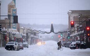 A cyclist crossed Chestnut Street in Virginia, Minn., in 2022. City workers in Virginia walked off the job Wednesday morning, as contract negotiations