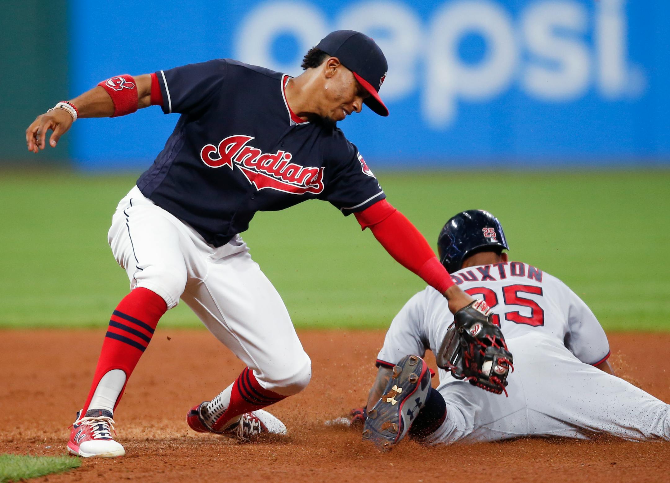 Minnesota Twins' Byron Buxton steals second base as Cleveland Indians' Francisco Lindor tries to apply the tag during the sixth inning in a baseball game, Tuesday, Sept. 26, 2017, in Cleveland. (AP Photo/Ron Schwane)