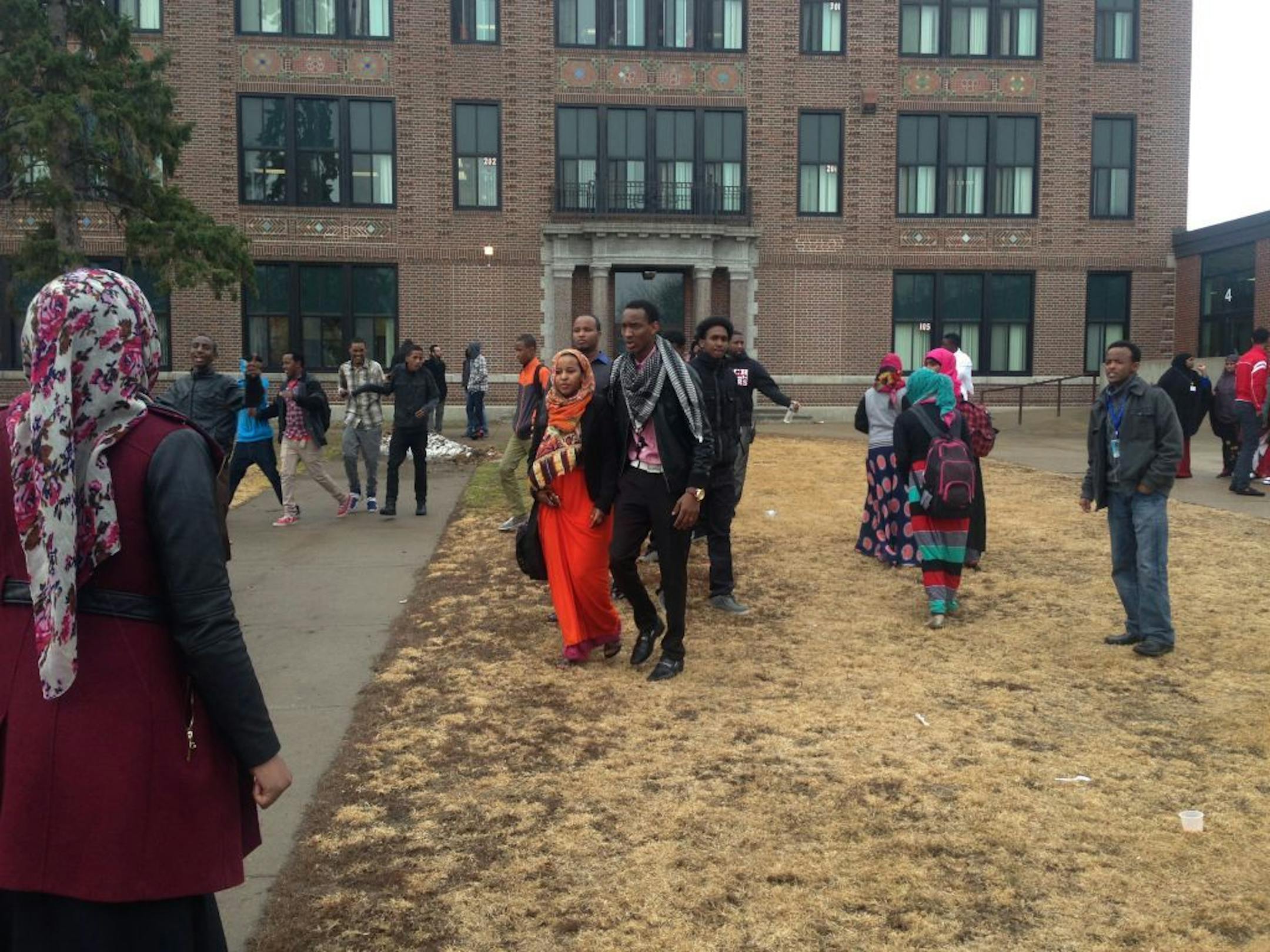 Senior Suda Salah, 19 (in orange) outside Tech High School on Friday with Somali classmates. The St. Cloud school district has been roiled by tensions between whites and Somali students for the last decade - so much so that it had to reach a settlement with the U.S. Dept. of Ed a few years back - and that reached a boiling point this week. More than 100 Somali students walked out to protest the administration's indifference to their complaints of bullying and harassment, particularly for the gir