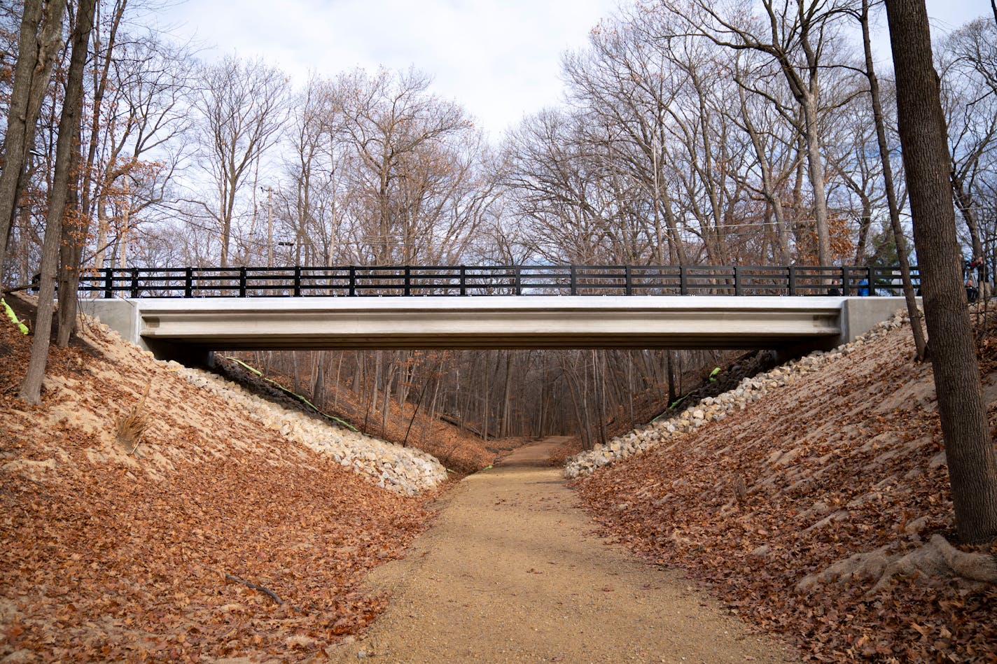 City and state leaders gathered at the new Northome Avenue bridge for a grand opening and dedication ceremony in honor of late Mayor Paul Skrede on Thursday, Dec. 2, 2021 in Deephaven, Minn. The bridge goes over a biking trail and is immediately west of the intersection of Northome Avenue and Parkway Street.