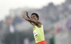 Ethiopia's Feyisa Lilesa crosses the finish line to place second at the men's marathon at the 2016 Summer Olympics in Rio de Janeiro, Brazil, Sunday, 