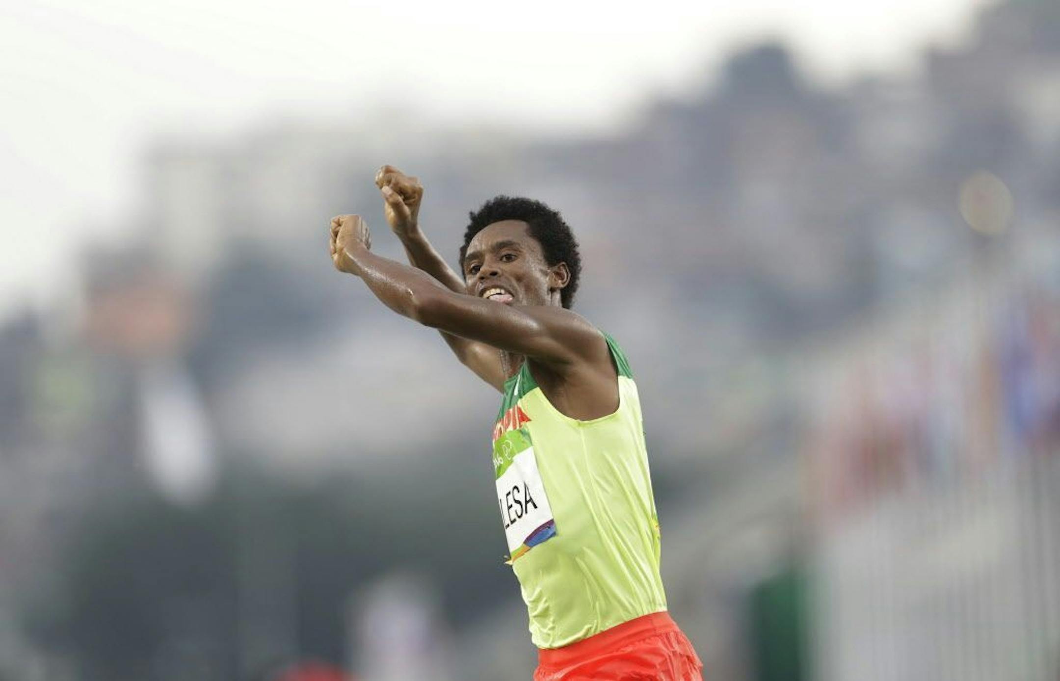 Ethiopia's Feyisa Lilesa crosses the finish line to place second at the men's marathon at the 2016 Summer Olympics in Rio de Janeiro, Brazil, Sunday, Aug. 21, 2016.