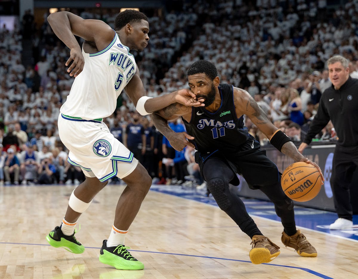Anthony Edwards of the Timberwolves defends Kyrie Irving of the Mavericks in the fourth quarter of Game 2 of the Western Conference finals at Target C