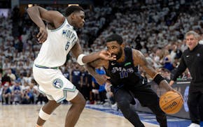 Anthony Edwards of the Timberwolves defends Kyrie Irving of the Mavericks in the fourth quarter of Game 2 of the Western Conference finals at Target C