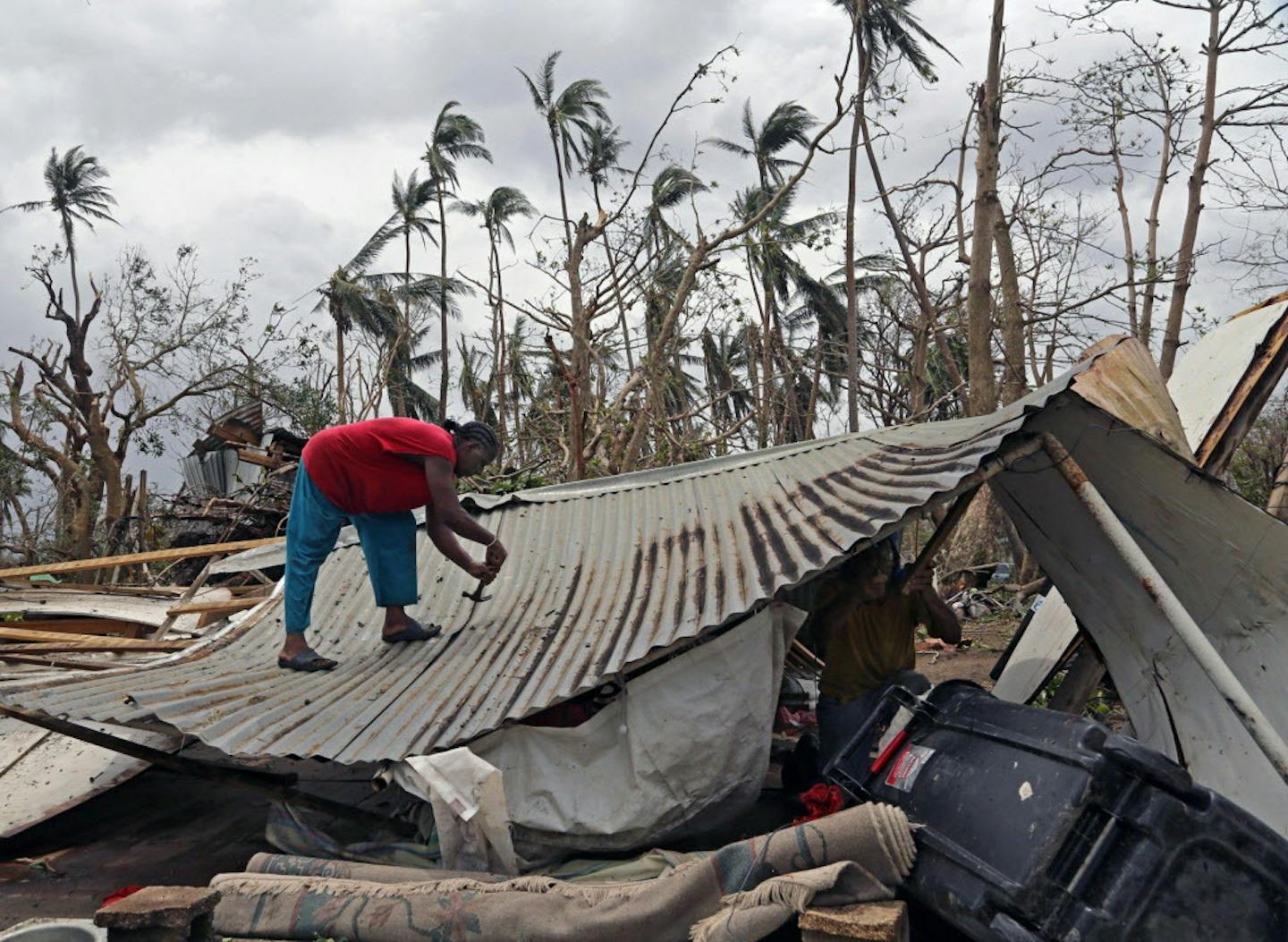 Jorge Diaz, 58, removes nails as he salvages items from his destroyed home, which he and his brother plan on rebuilding. Residents of the beach town of Loiza, Puerto Rico, who received heavy flooding and wind damage, have no power, no running water, but are working to piece their lives back together as Puerto Rico tries to recover from the Category 4 storm on Friday, Sept. 22, 2017. (Carl Juste/Miami Herald/TNS) ORG XMIT: 1211766