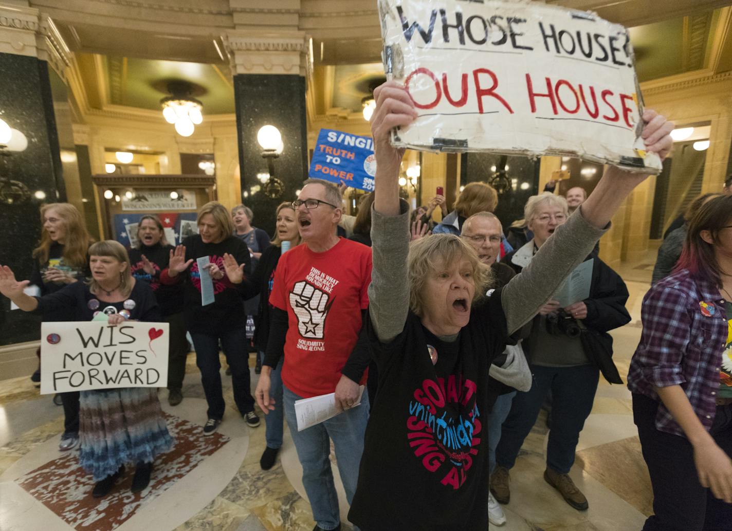 About 120 people associated with the Solidarity Singers, belt out songs with joy while celebrating the defeat of Republican Gov. Scott Walker during the lunch hour Wednesday, Nov. 7, 2018 at the Capitol in Madison, Wis. Since 2011, a group of singers have gathered on most weekdays at noon to protest Walker and Republican lawmakers. An eight-year reign of Republican dominance and political muscle in this state came to an end Tuesday when Democrat Tony Evers defeated GOP Gov. Scott Walker, the cen