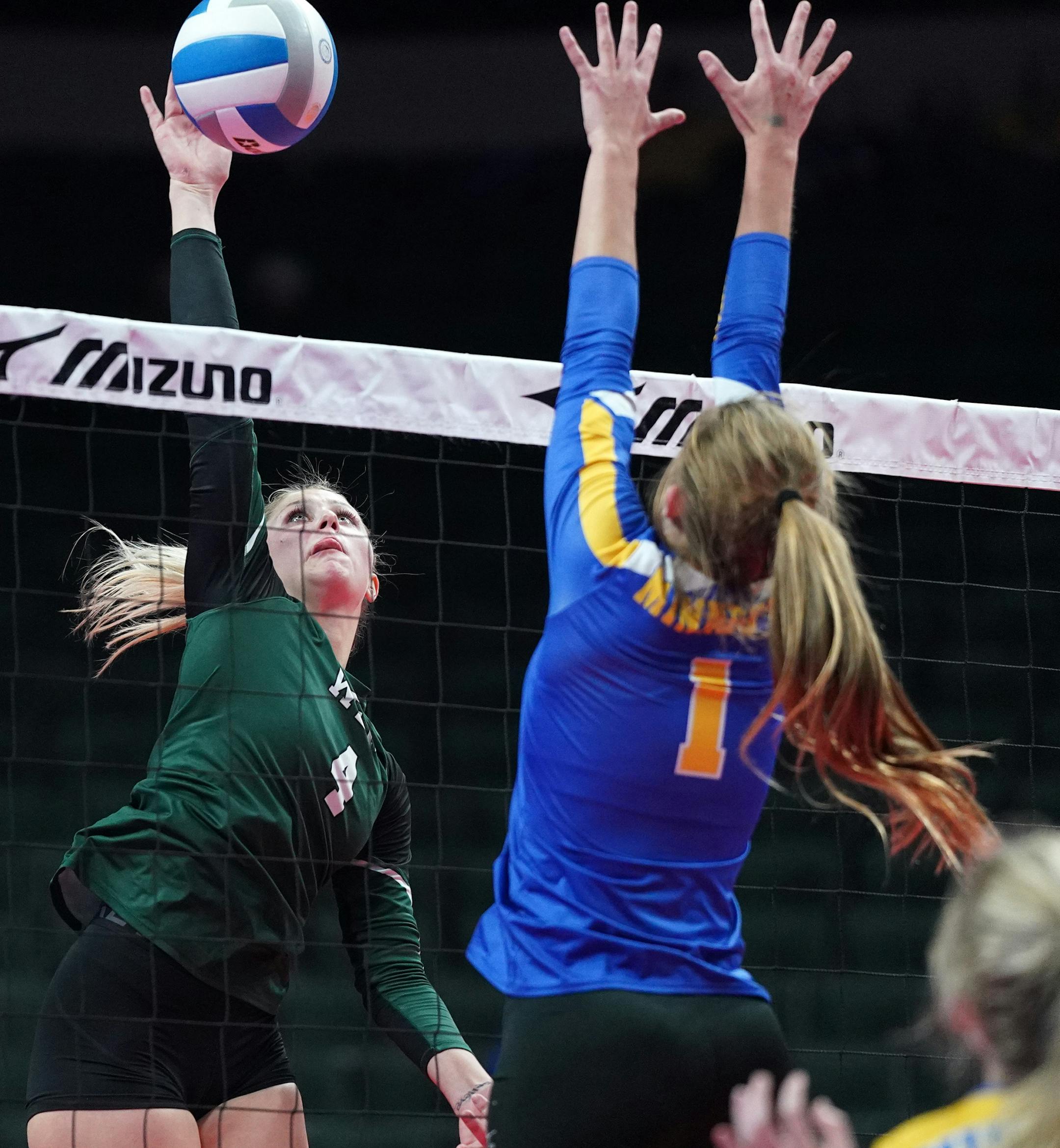 WEM middle hitter Delaney Donahue (4) spiked the ball as Minneota outside hitter Abby Hennen (1) leapt to block in the third set. ] ANTHONY SOUFFLE • anthony.souffle@startribune.com Minneota played Waterville-Elysian-Morristown in a MSHSL Class 1A volleyball state championship game Saturday, Nov. 9, 2019 at Xcel Center in St. Paul, Minn.