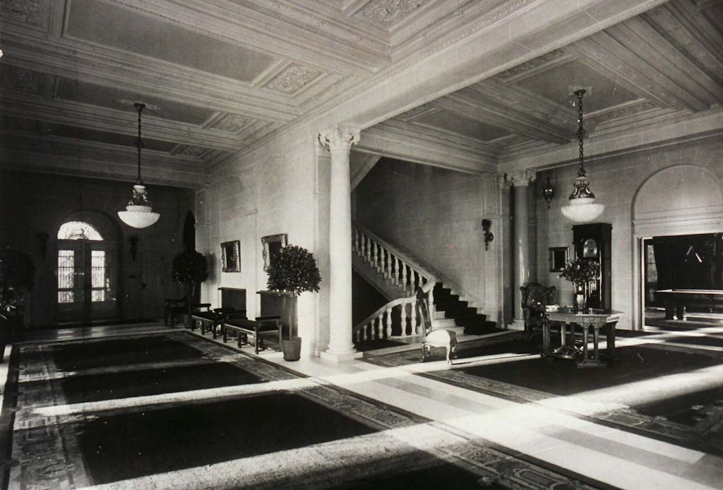 The staircase and a portion of a long gallery, which was white marble with a 70-foot-long red carpet, at the Charles Gates mansion in the early to mid 1920s.