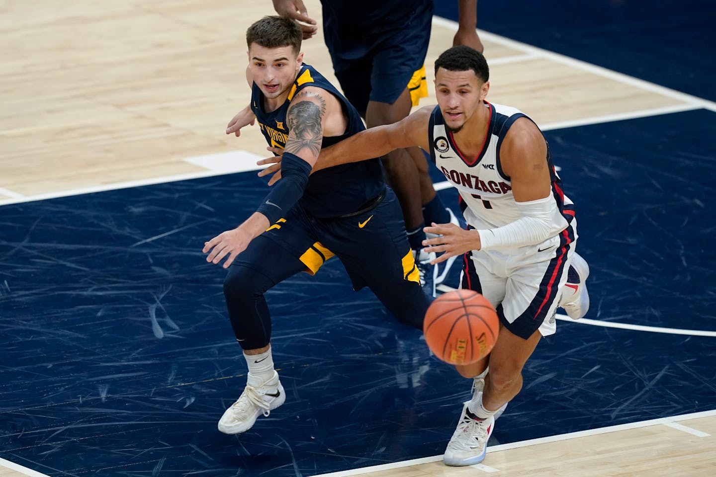 West Virginia's Jordan McCabe (5) and Gonzaga's Jalen Suggs (1) eye a loose ball during a game Dec. 2.