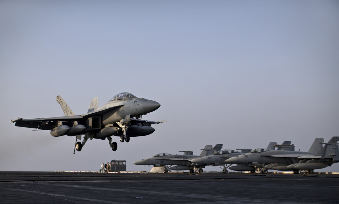 A U.S. Navy fighter jet is about to land on the flight deck of USS Theodore Roosevelt aircraft carrier, Thursday, Sept. 10, 2015. The carrier is currently deployed in the Persian Gulf, supporting Operation Inherent Resolve, the military operation against Islamic State extremists in Syria and Iraq.