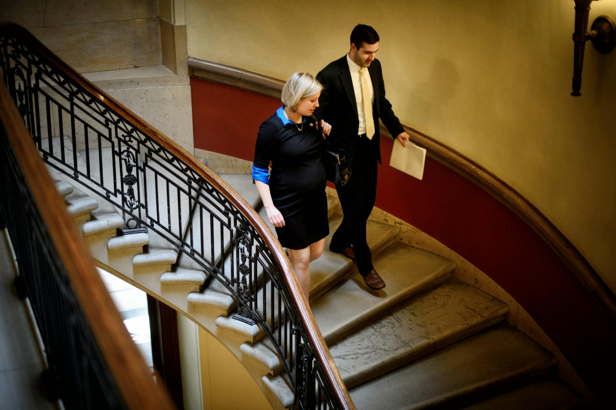 Rep. Carly Melin walked to a hearing with Matt Roznowski, DFL communications.