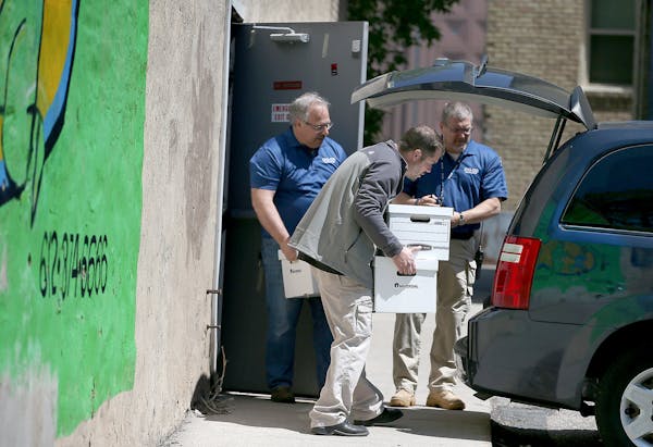 Officials from the DHS and BCA removed boxes and computer equipment from the Salama Child Care Center on Wednesday, May 14, 2015.