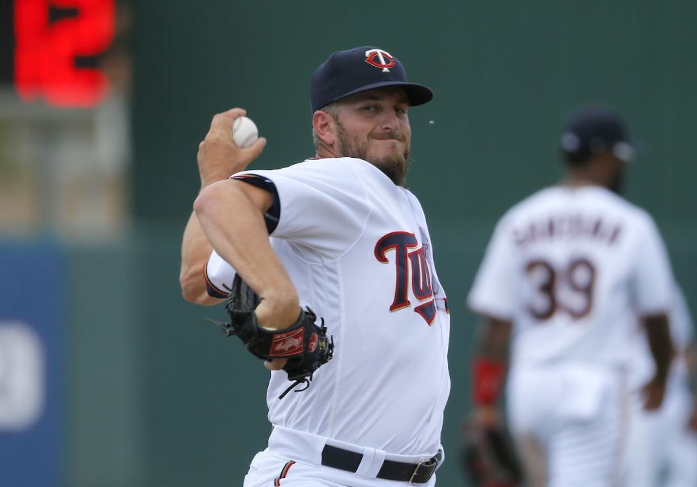 Minnesota Twins' Glen Perkins throws a warm up pitch in the seventh inning of a spring training baseball game against the Tampa Bay Rays on Wednesday, March 23, 2016, in Fort Myers, Fla.