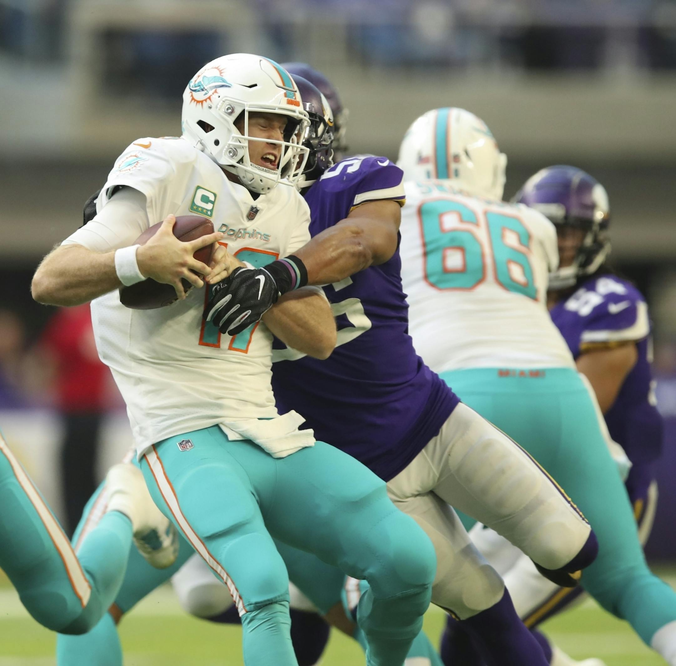 Miami Dolphins quarterback Ryan Tannehill (17) was wrapped up for a sack by Minnesota Vikings outside linebacker Anthony Barr (55) for a nine yard loss in the third quarter.